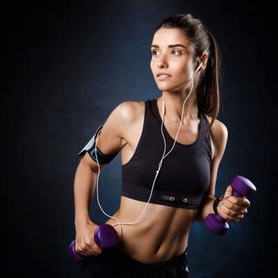 Young Beautiful Sportive Girl Training With Dumbbells Dark Wall