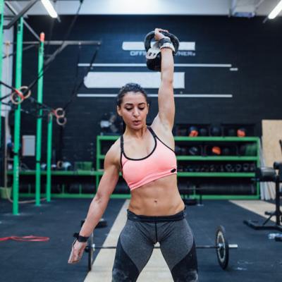 Young Woman Training Swinging Kettlebell Indoor Crossfit Gym
